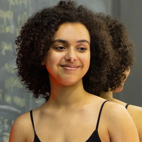 Mixed race woman with curly hair smiling